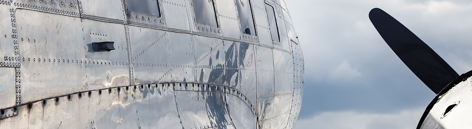 Side of a metal riveted airplane