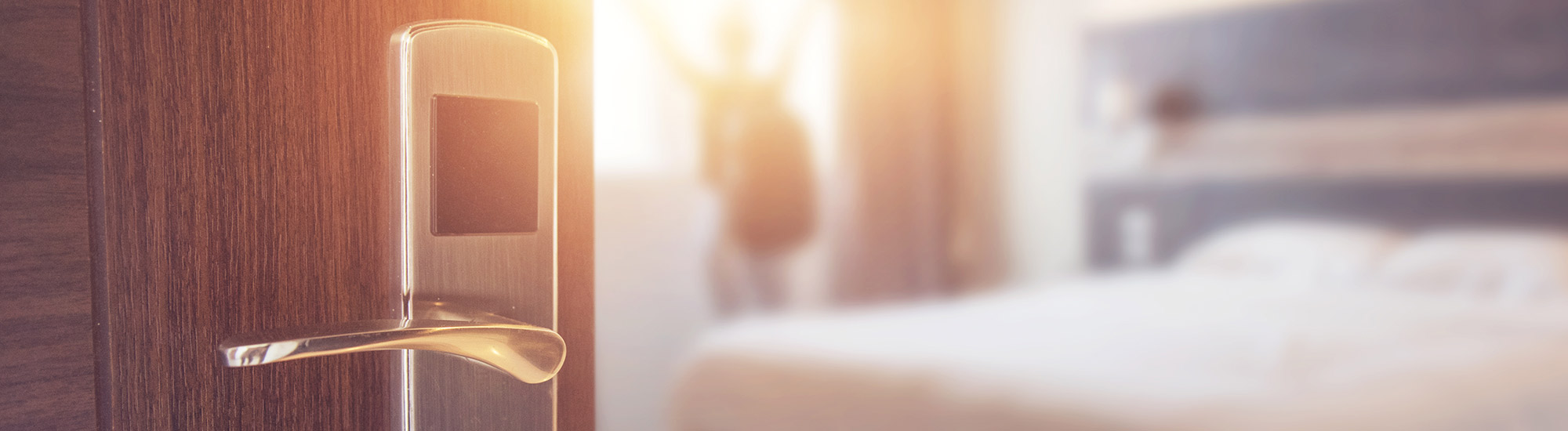 hotel room door knob with open door and blurry room